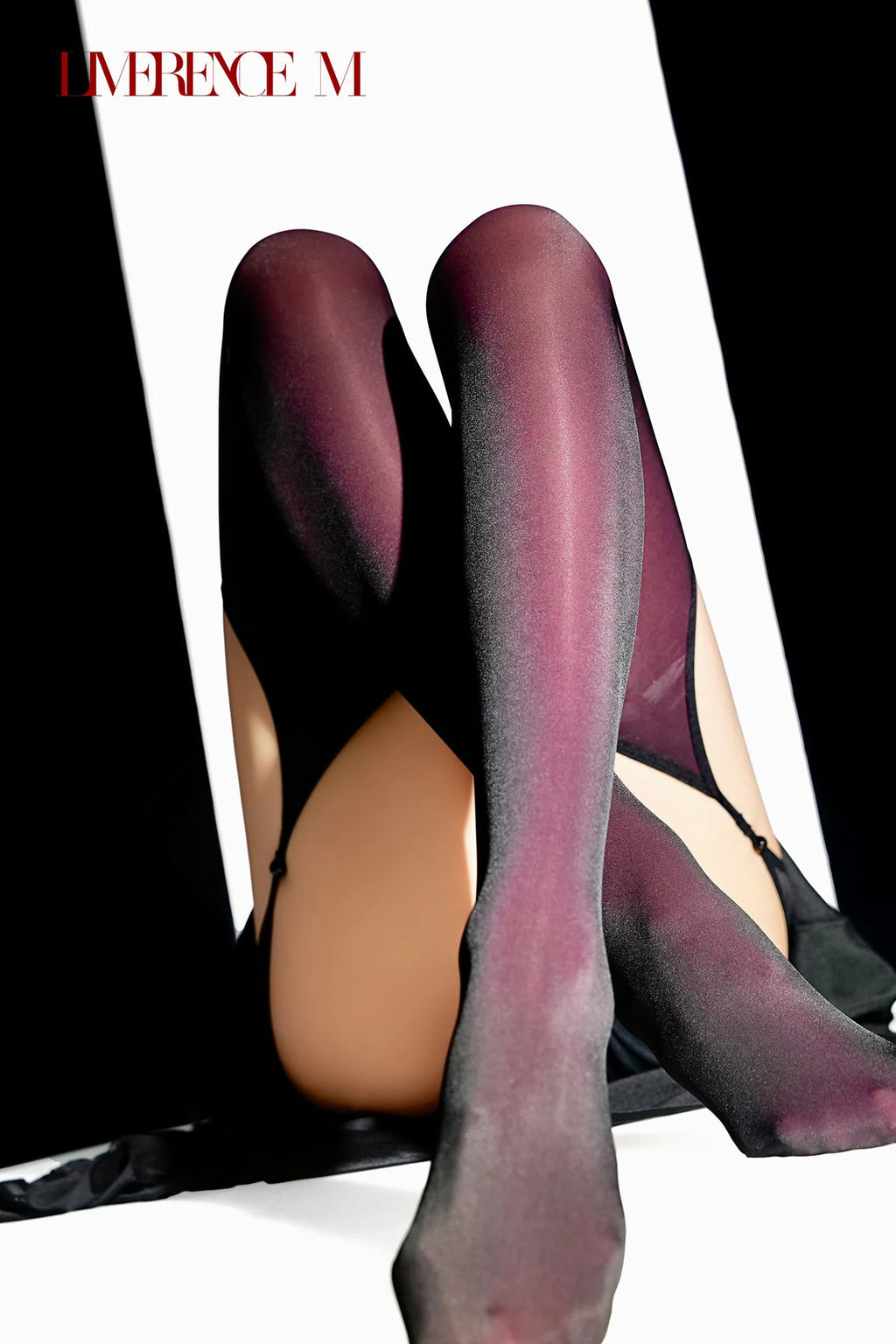 Raised legs wearing Gem 150D burgundy one-piece garter stockings