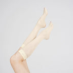 Raised legs wearing Graceline 8D pale-yellow plaid knee-high socks
