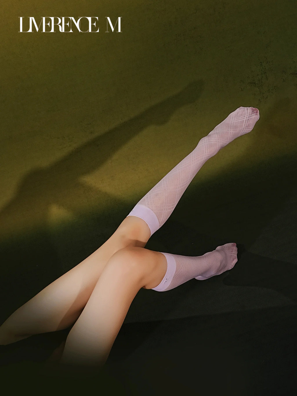 Legs extended in Graceline 8D lavender plaid knee-high socks