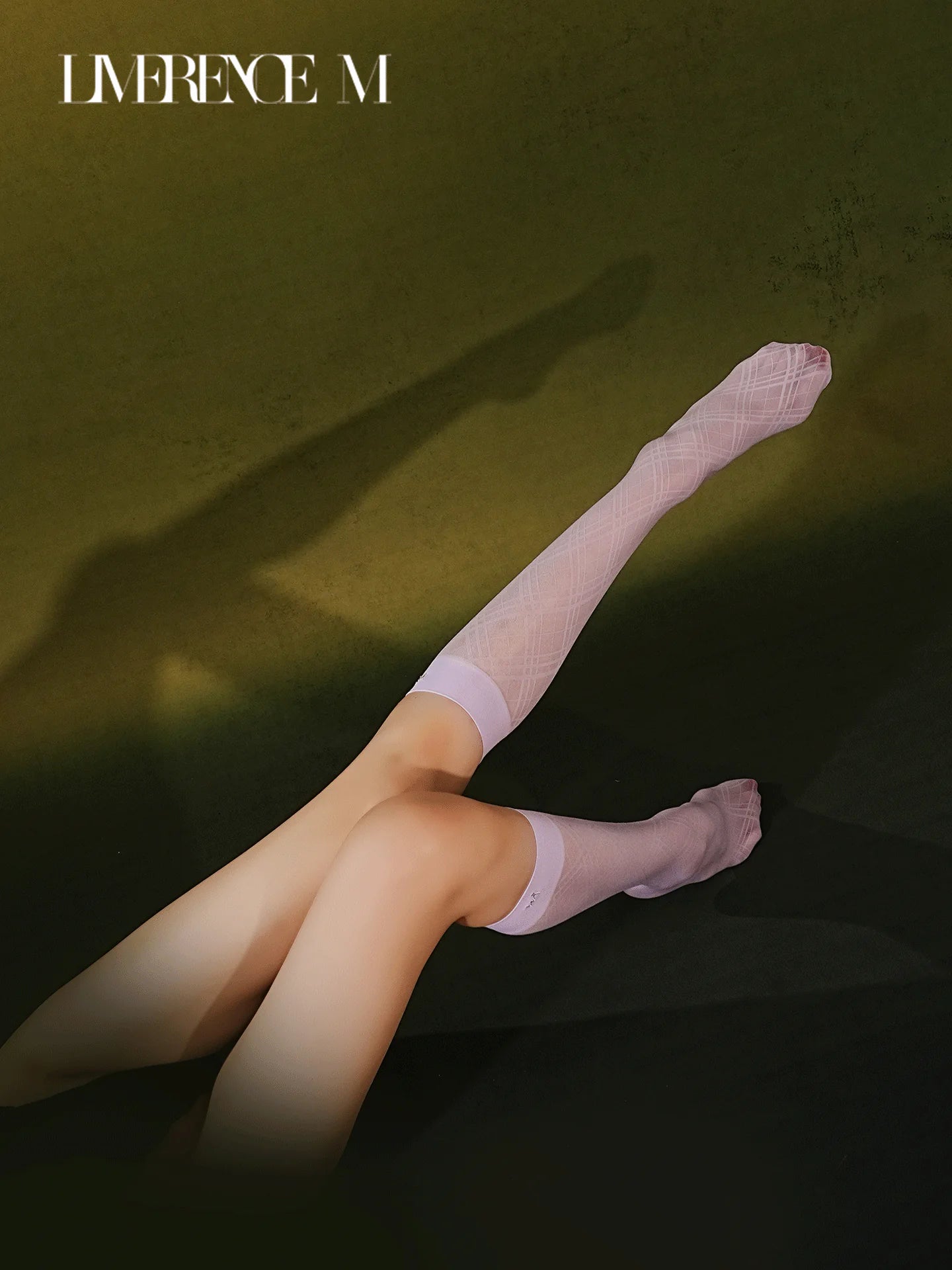 Legs extended in Graceline 8D lavender plaid knee-high socks