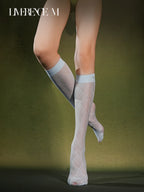 Crossed legs wearing Graceline 8D light-blue plaid knee-high socks