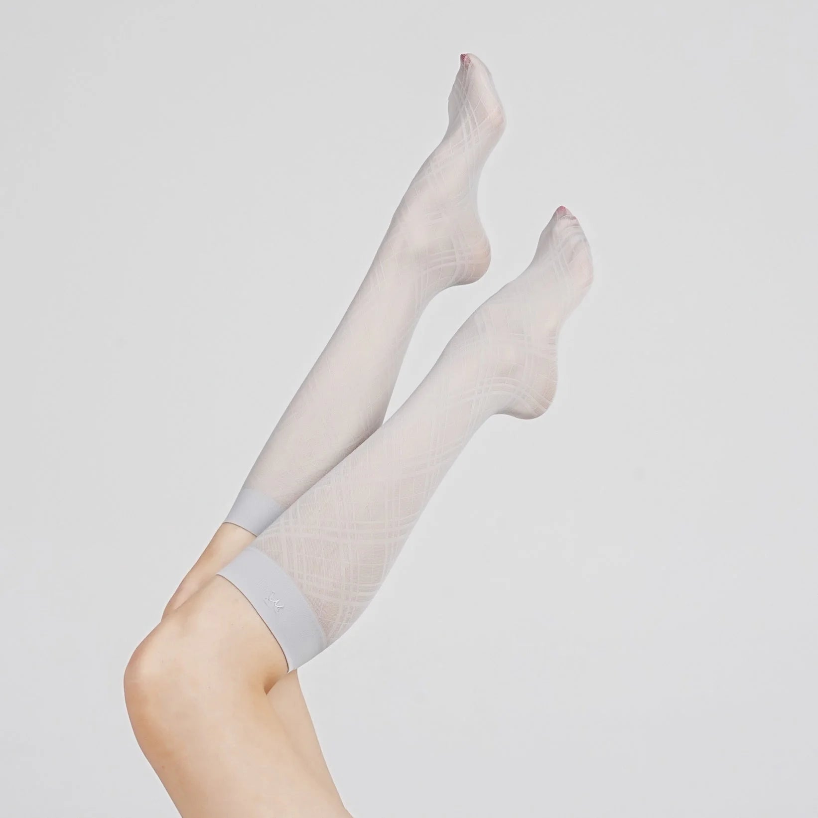 Product view of Graceline 8D light-blue plaid knee-high socks on raised legs