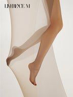 Bare-foot pose in Melt 1D nude ultra-sheer pantyhose