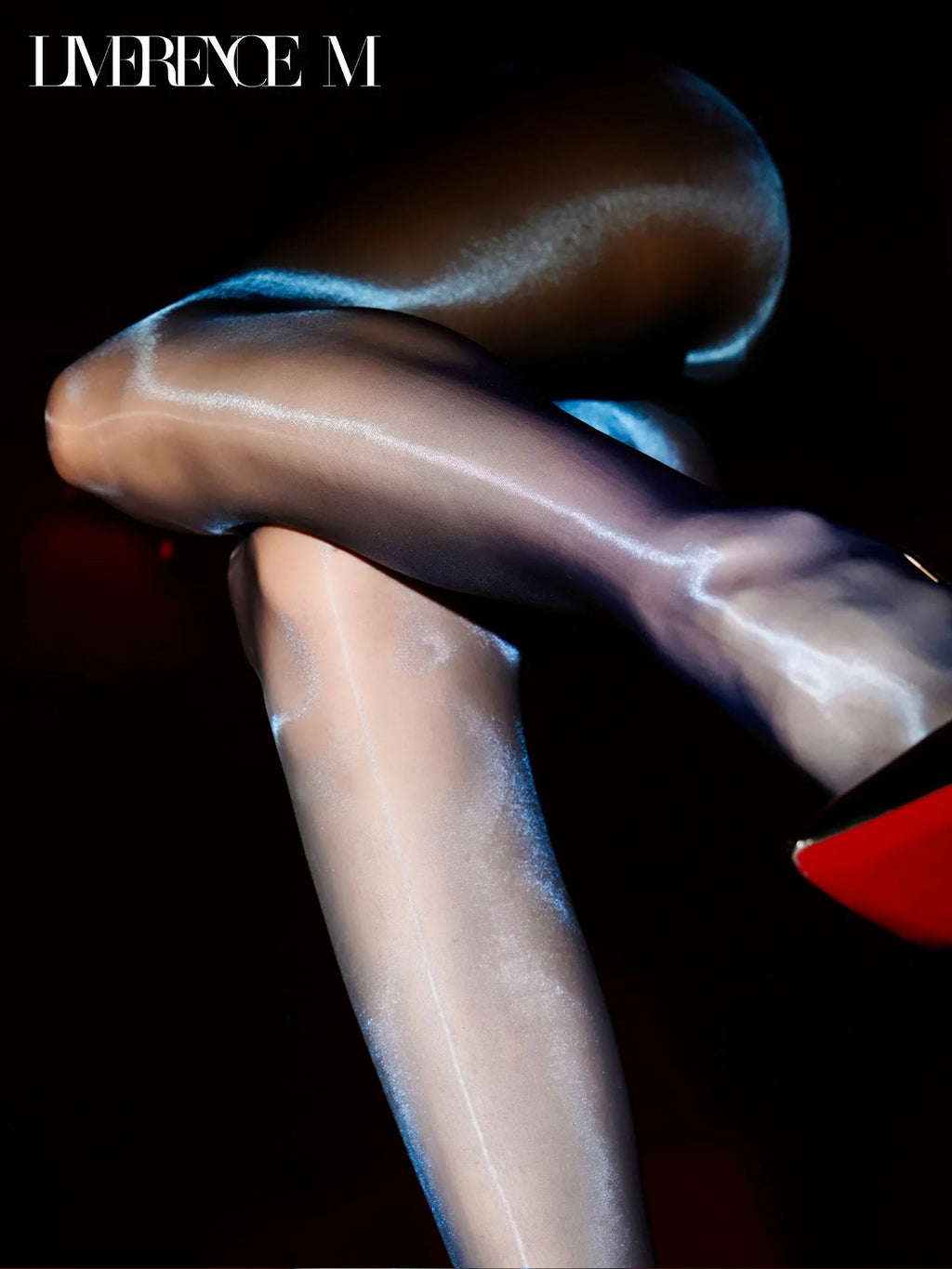 Close-up of crossed legs in Prism 15D black high-shine pantyhose