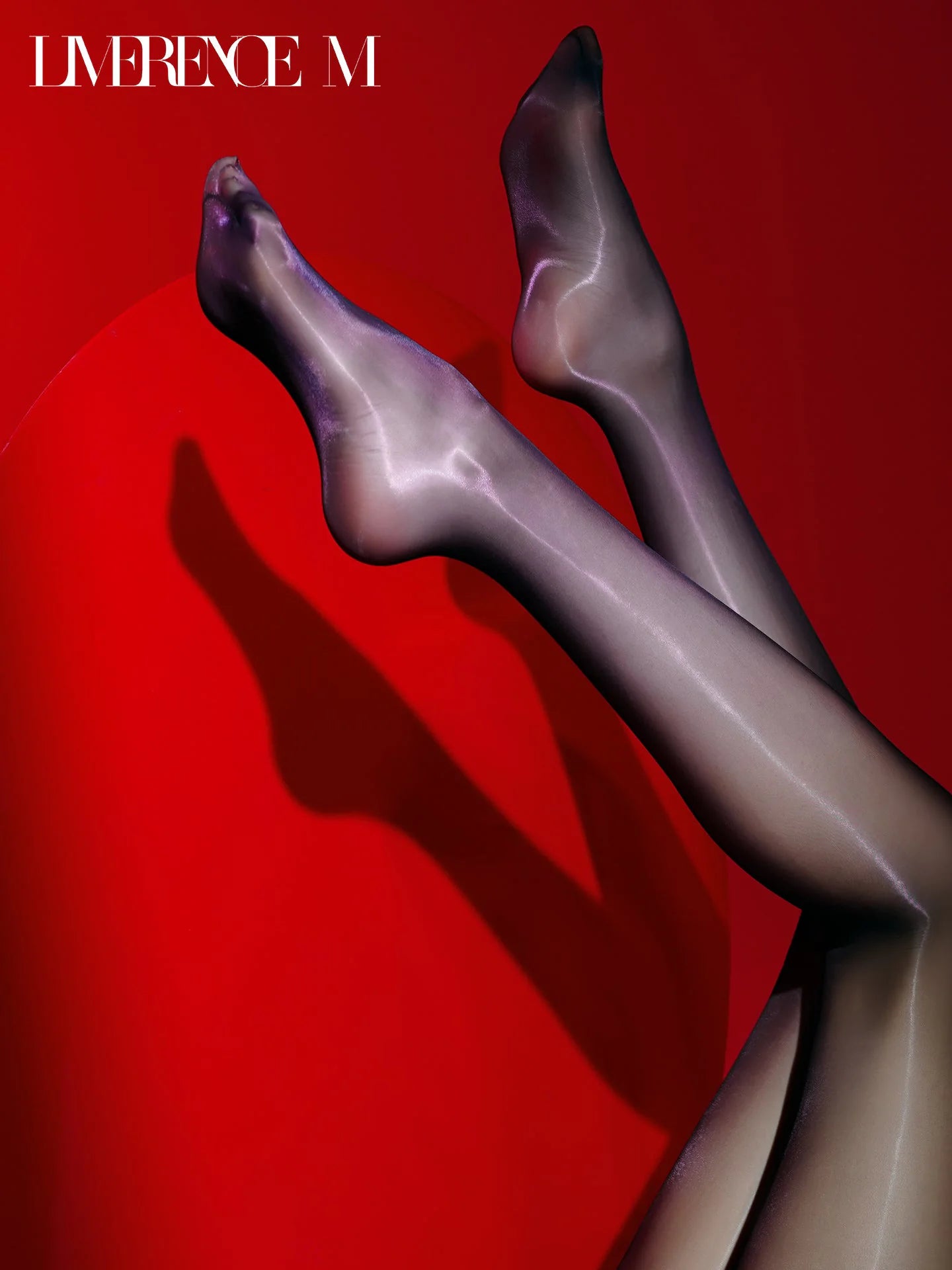 Raised legs wearing Prism 3D black high-shine pantyhose